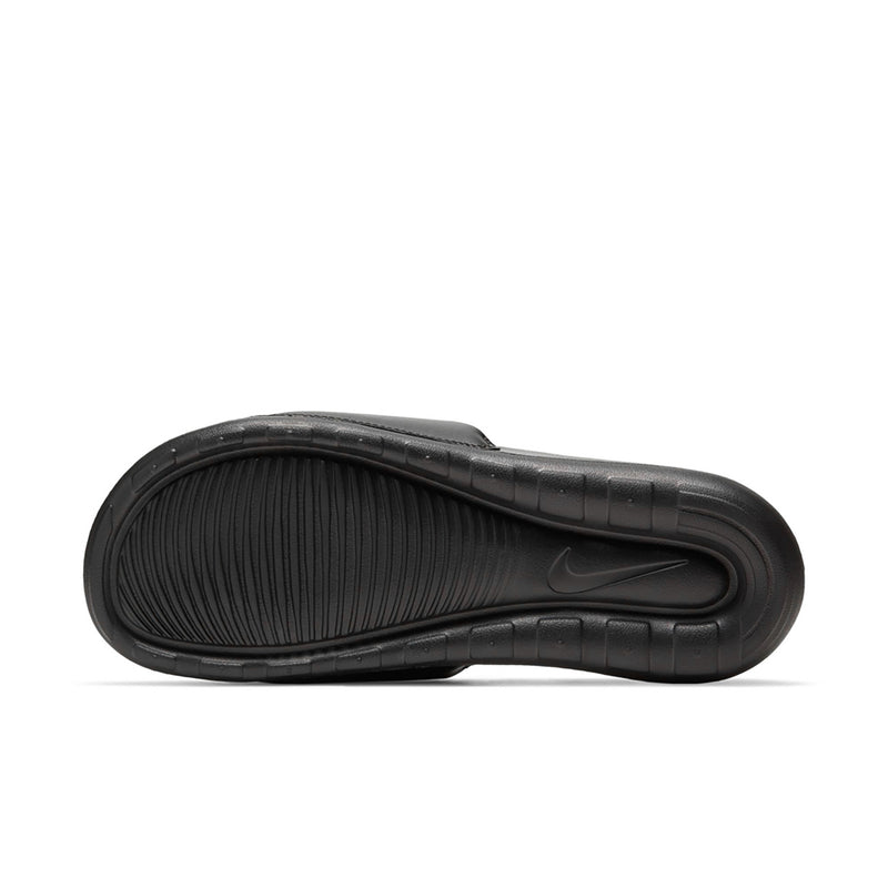 Black slide sandal sole with textured tread pattern and Nike branding