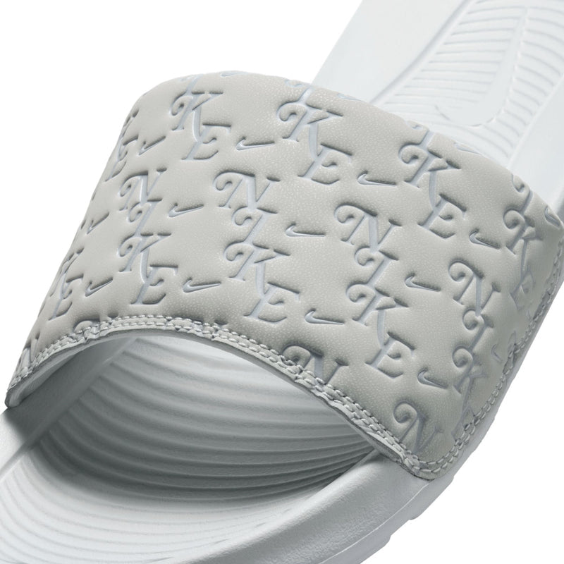 Women’s slide sandal close-up: light gray embossed logo-pattern strap