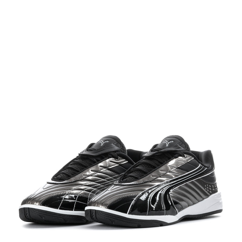 Youth sneakers pair, black with silver accents, lace-up with strap, white sole