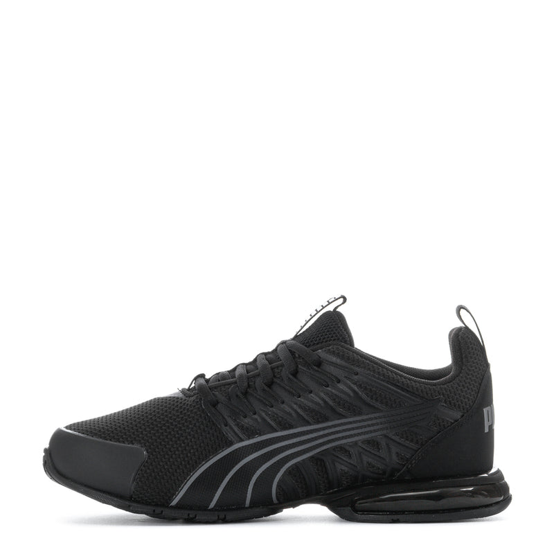 Black lace-up youth athletic sneakers with side stripes and Puma emblem, low-profile sole