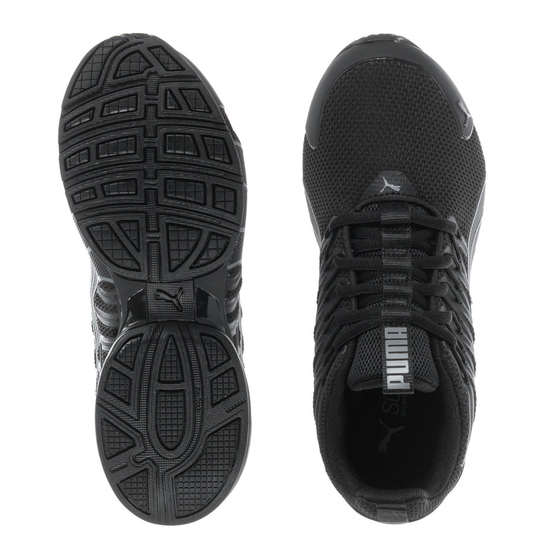 Black youth sneaker pair showing tread outsole and side mesh upper with Puma logo