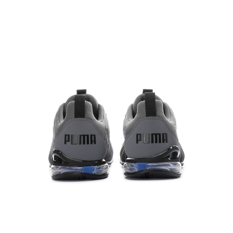 Men's dark grey/black shoes, heel view with PUMA branding and blue air-cushion sole