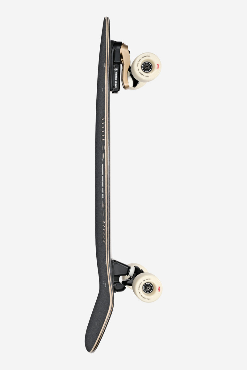 Side view of Walrus 31in Black Peaking surf skate board with cream wheels and black trucks