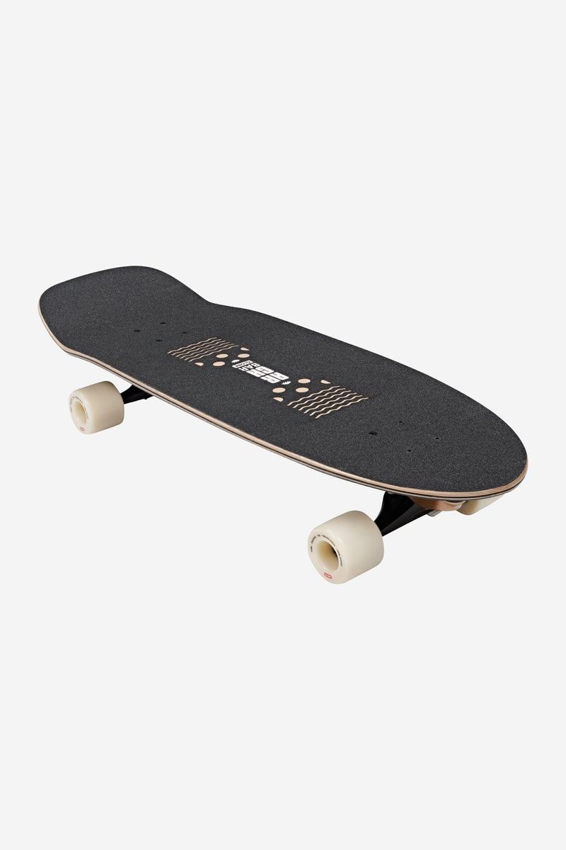 Three-quarter view of Walrus 31in Black Peaking board showing black grip tape and cream wheels