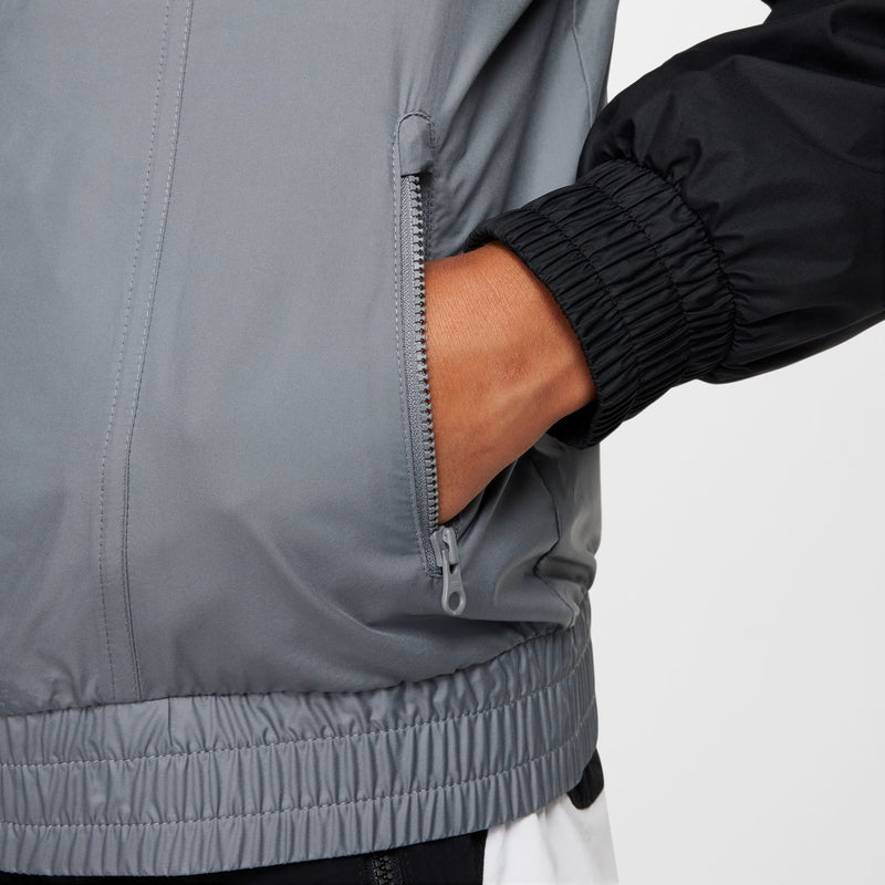 Smoke grey windbreaker jacket with front zipper, elastic hem, and black sleeve cuff