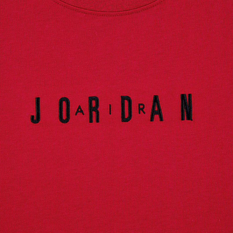 Close-up of embroidered "JORDAN" wordmark on Gym Red T-shirt front