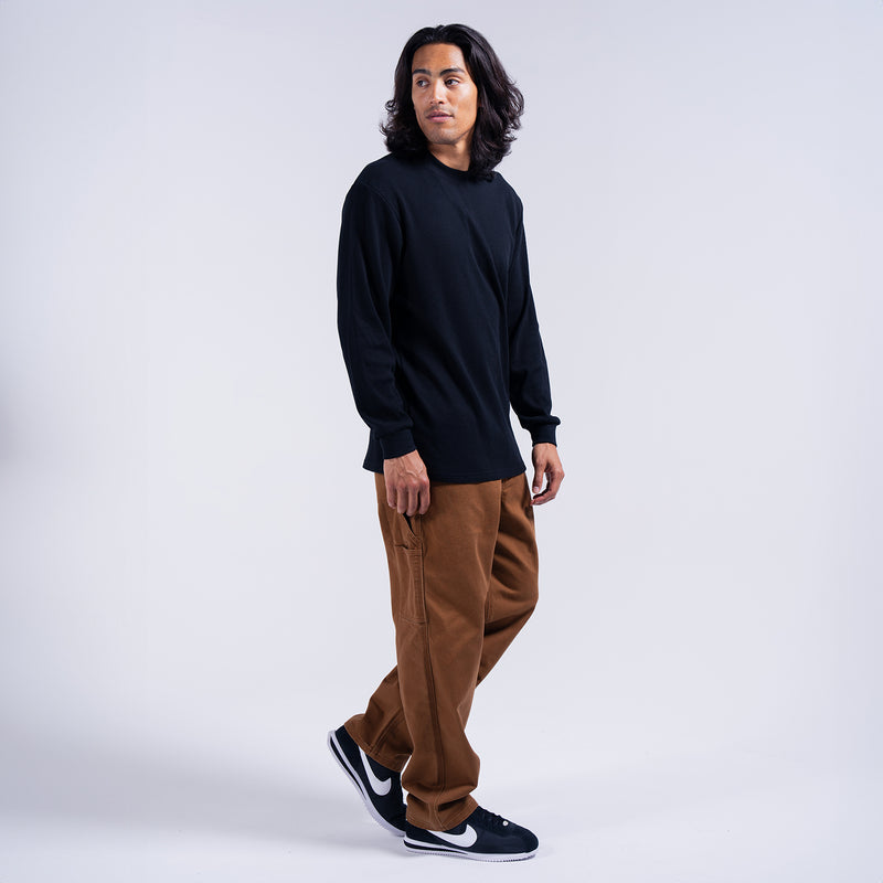 Men's brown work pants on model, loose fit with cargo pockets