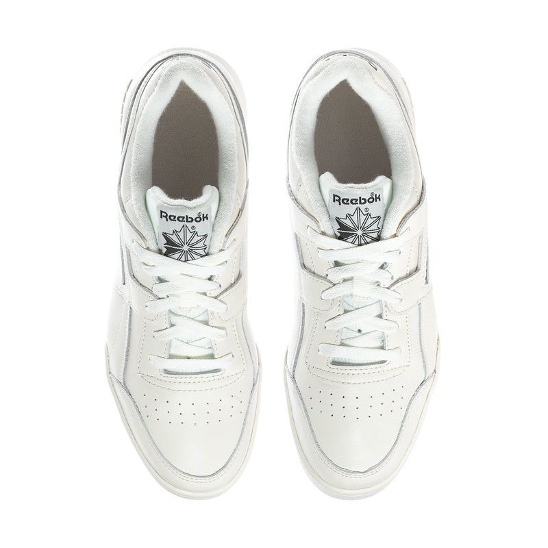 White lace-up sneakers with Reebok emblem on tongue and perforated toe.