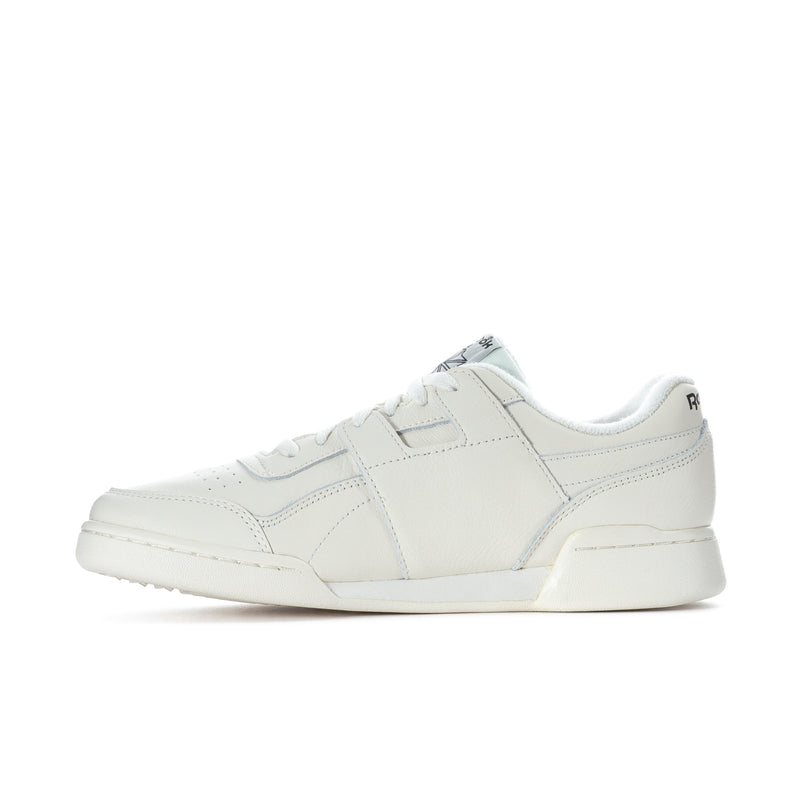 White low-top lace-up sneakers with side seam stripes and Reebok logo.