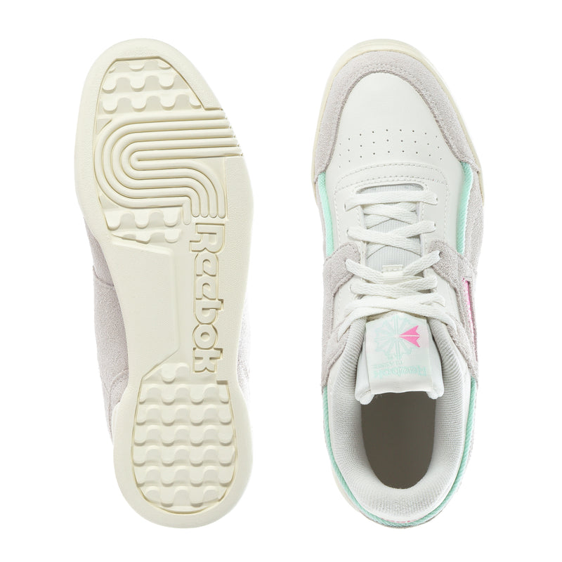 Youth sneaker outsole and heel view with white tread and mint-trimmed collar