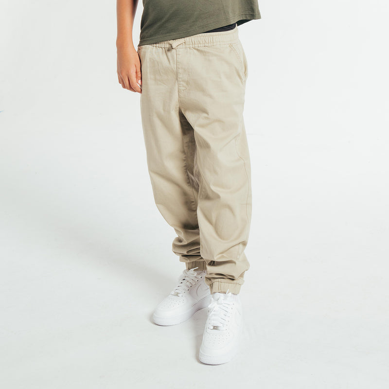 Youth woven jogger pants shown from side with cuffed ankle and slant pockets
