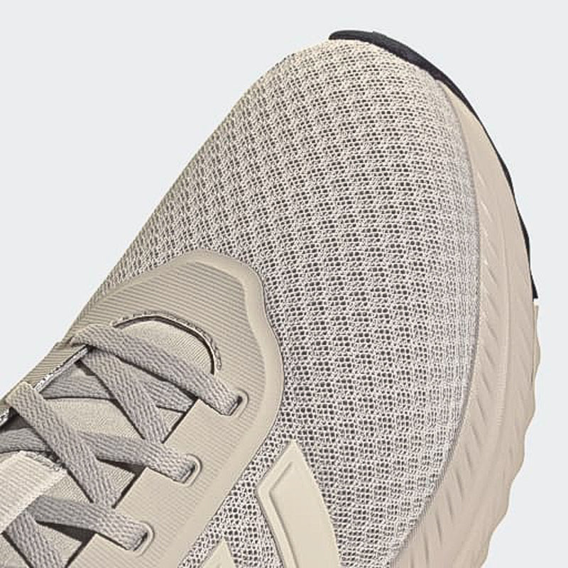 Men's sneaker upper close-up, textured gray fabric with light beige overlays