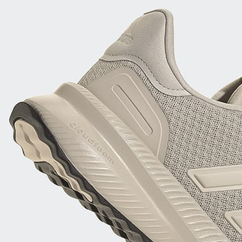 Men's sneaker side close-up, gray mesh upper with ridged light rubber sole