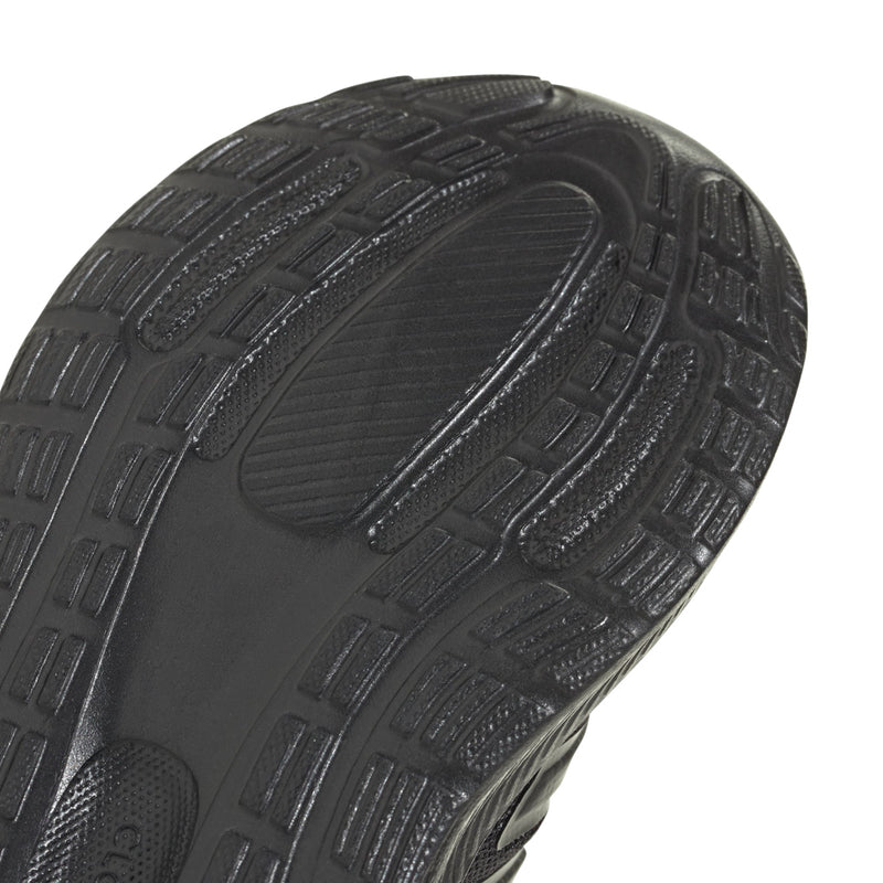 Close-up of black sneaker outsole tread pattern with traction grooves