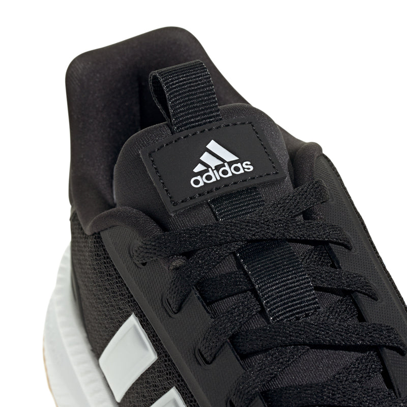 Close-up of black womens running shoe upper with adidas patch and lace details