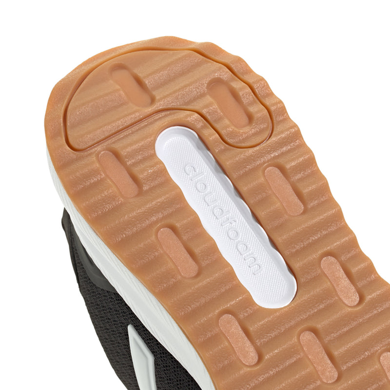 Close-up of black womens running shoe outsole with textured traction and adidas logo strip