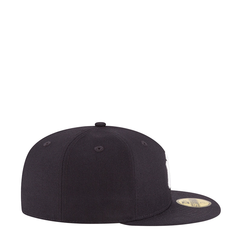 Dark baseball cap, side view with curved brim and top button