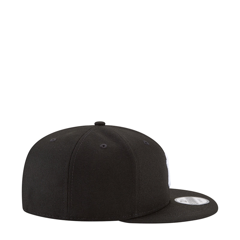 Black baseball cap with curved brim and side panel stitching