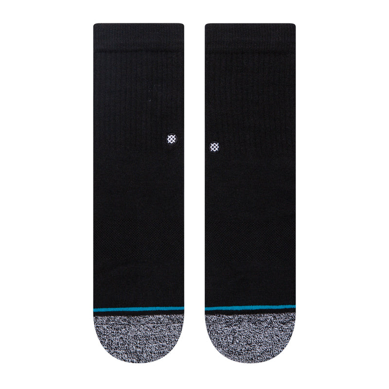 Pair of black crew socks, gray footbed, blue stripe, small white logo on back.