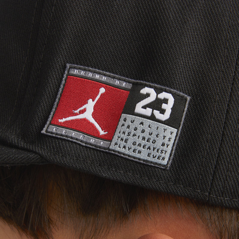 Black snapback close-up of red-and-white 'JORDAN 23' logo patch