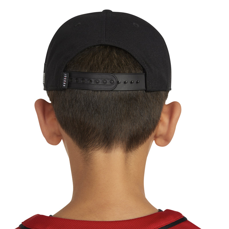 Black snapback cap from back with adjustable strap across the closure