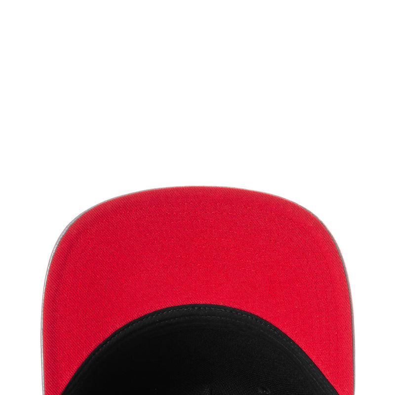 Youth snapback cap, close-up red crown with black interior underbrim