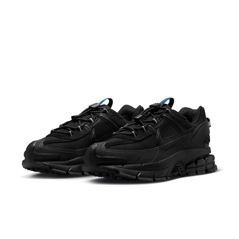 Women’s black trail running shoes with blue lace accents and rugged tread sole