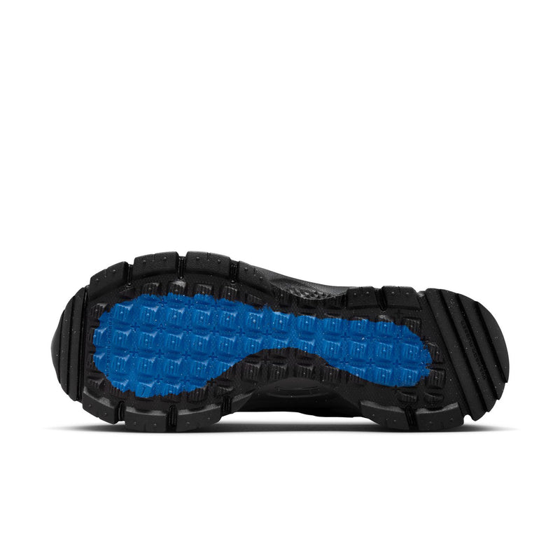Women’s black outsole with blue traction pads and deep multi-direction tread